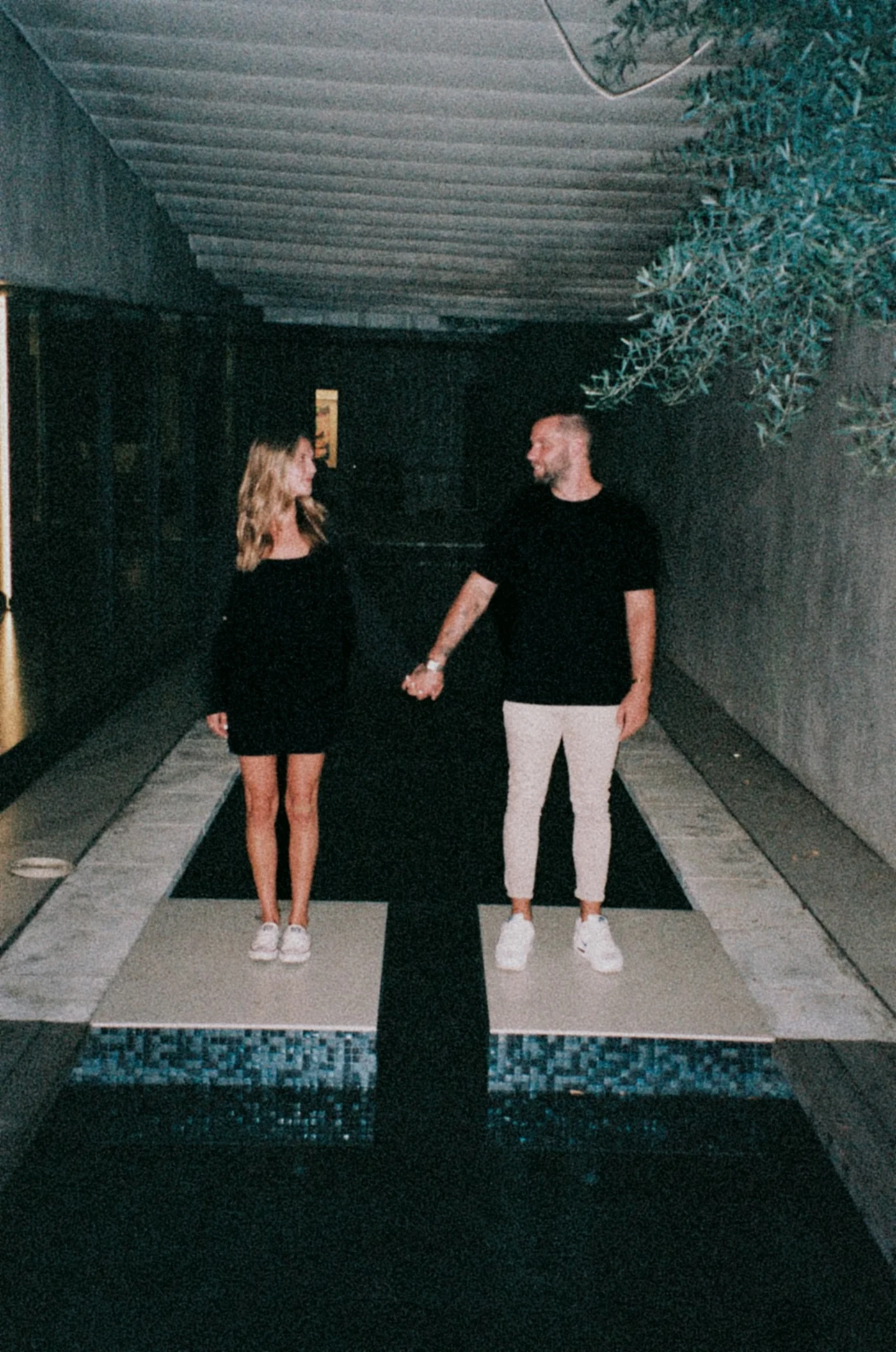 Zach Schubert and his companion beside a reflecting pool