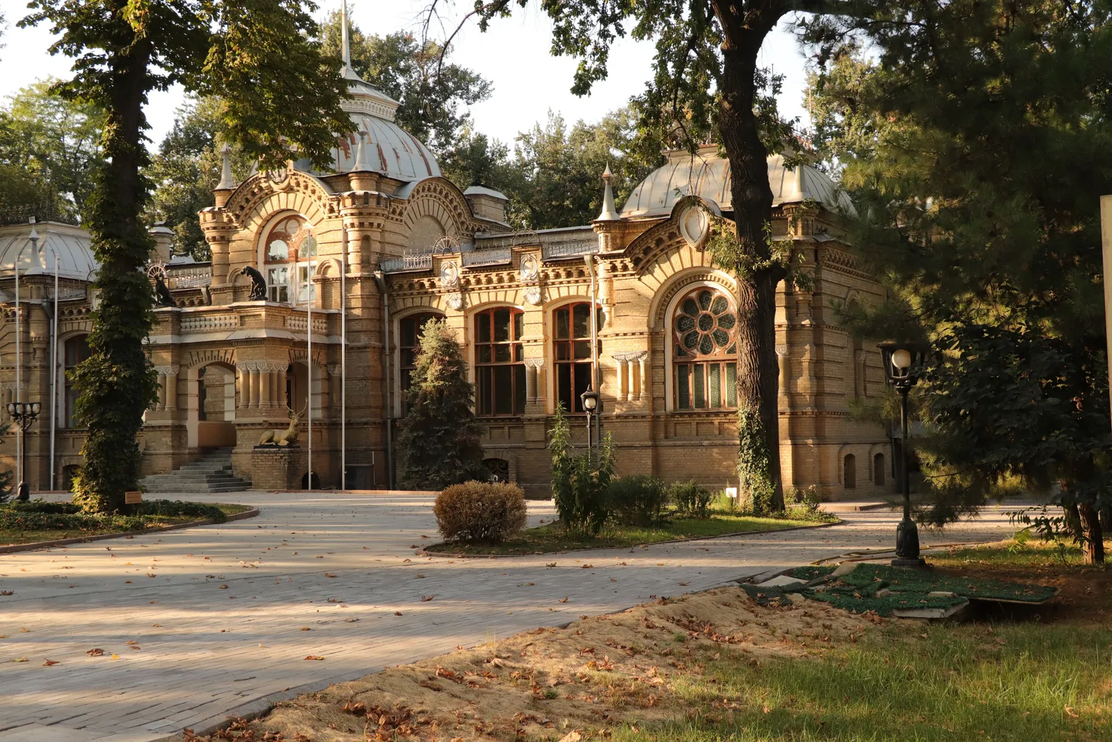 Stone house entrance framed by mature trees