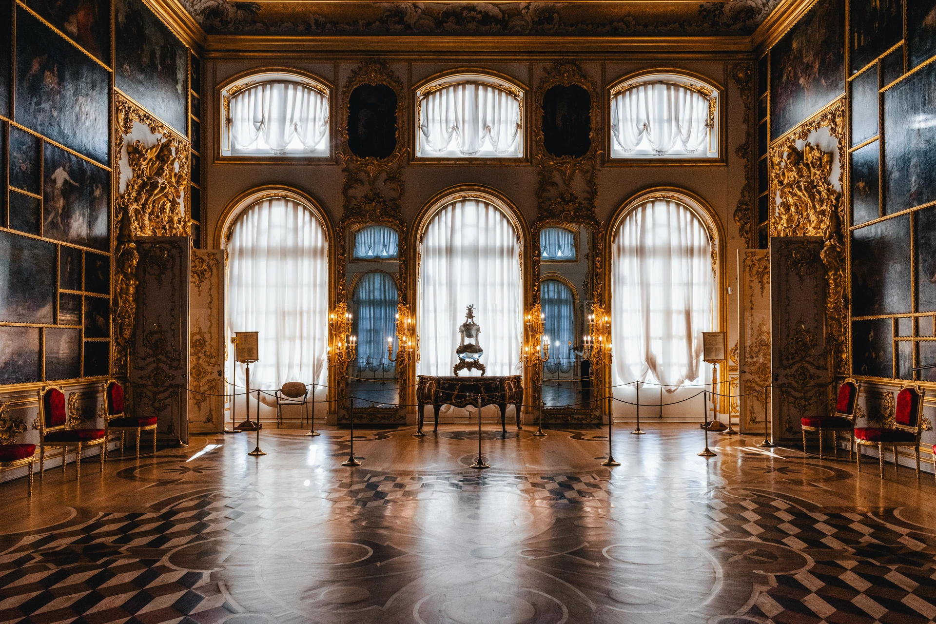 Tall windows and a patterned floor in a historic hall